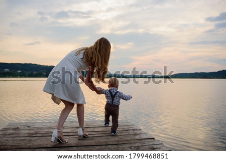 Mother and her one-year-old son. The family is having fun together in nature.