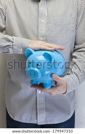 Holding a Piggy Bank