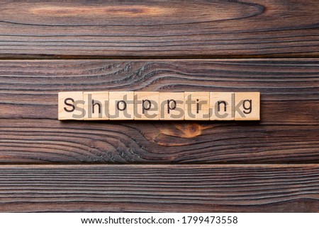 shopping word written on wood block. shopping text on cement table for your desing, concept.