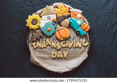Happy Thanksgiving Day. Multicolored autumn cookies on a black background. Autumn concept