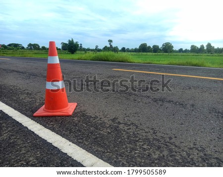 road construction with a red rubber cone in front in thailand

