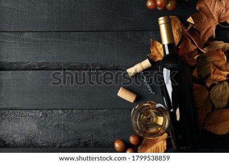 Composition with wine and grape on wooden background, top view