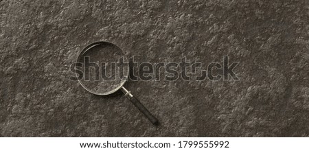 magnification glass on the left on empty stone background - 3d illustration