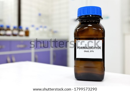 Selective focus of formaldehyde or formalin in brown amber glass bottle inside a laboratory. Blurred background with copy space. Royalty-Free Stock Photo #1799573290