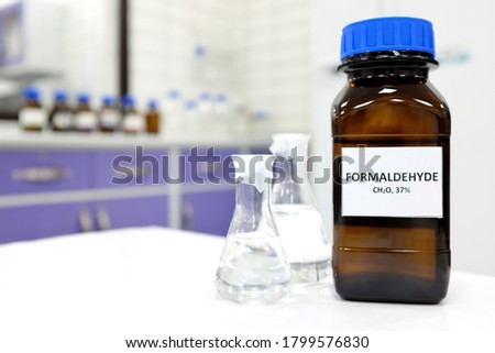 Selective focus of formaldehyde or formalin in brown amber glass bottle inside a laboratory. Blurred background with copy space. Royalty-Free Stock Photo #1799576830