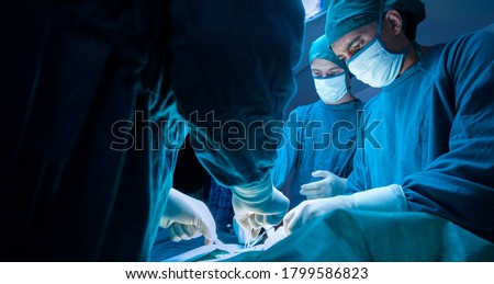 concentrated professional surgical doctor team operating surgery a patient in the operating room at the hospital. healthcare and medical concept. Royalty-Free Stock Photo #1799586823