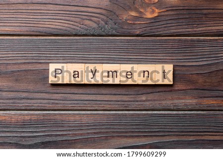 Payment word written on wood block. Payment text on cement table for your desing, concept.