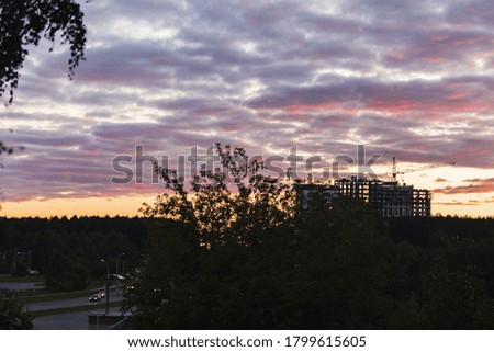 Cloudy colorful sunset over a building under construction