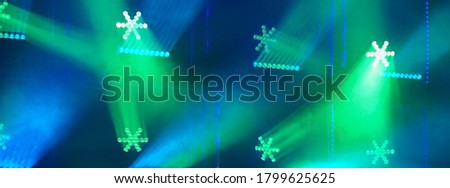 Futuristic bright lights on stage. Lighting of stage spotlight. Natural high tech background. Colorful Chistmas ornament. Photography suitable as postcard design, greeting card background, template.
