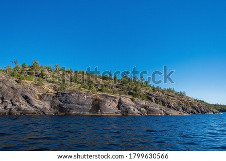 A sense of complete freedom. Amazing view of the nature of Karelia with skerries, fjords and mountains. Beautiful reflection. Ladoga skerries, Scandinavian landscape, Russia. Art picture.