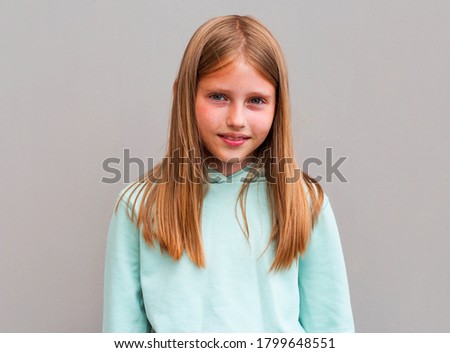 Portrait of beautiful blonde girl smiling looking at camera