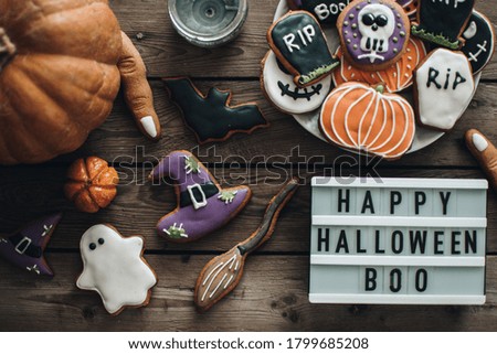 Halloween cookiesfor the party. Pumpkins. Autumn mood. White lightbox on the wooden background.