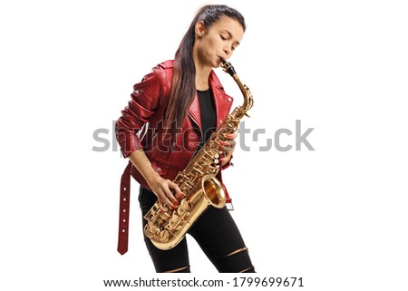 Young female saxophonist in a red leather jacket playing jazz music isolated on white background Royalty-Free Stock Photo #1799699671