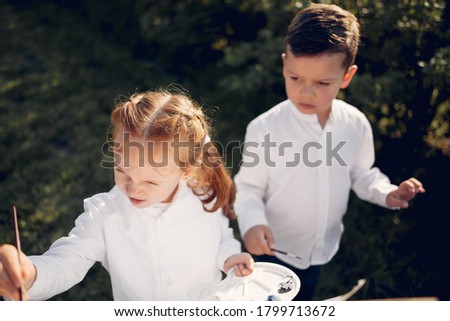 Little children in a summer park. Cute kids drawing