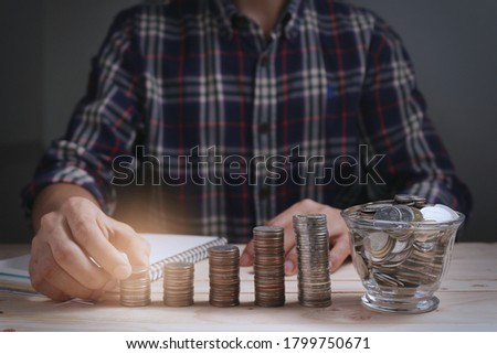 Man holding coin with concept saving money for finance accounting with growing business