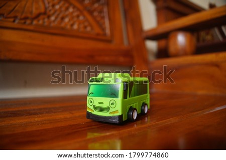 green toy bus with out of focus background