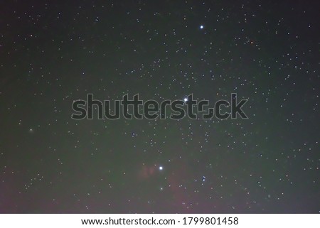 Universe and Orion constellation in the night sky.