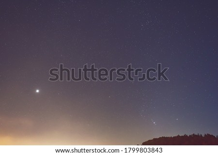 Venus planet and Orion constellation in the night sky.