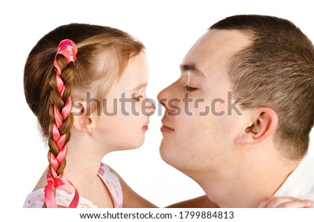 Little girl kissing her father isolated on a white 