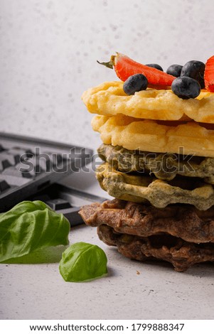 selective focus, curd waffles with vanilla and fresh berries on a light background