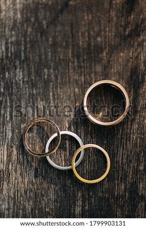golden wedding rings on wooden background, copy space