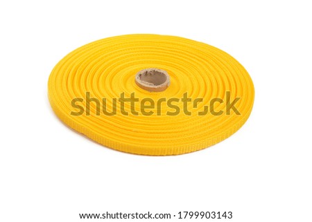 Illuminating yellow stripe round bobbin cotton tape. strong braided webbing for making belts, on a white background.