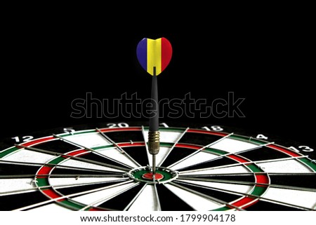 The flag of Romania is featured on the dart board game, the concept of achieving goals.