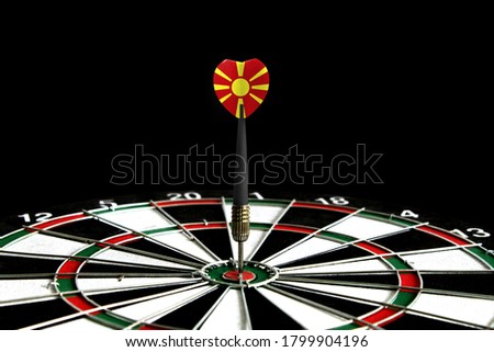 The flag of Macedonia is featured on the dart board game, the concept of achieving goals.