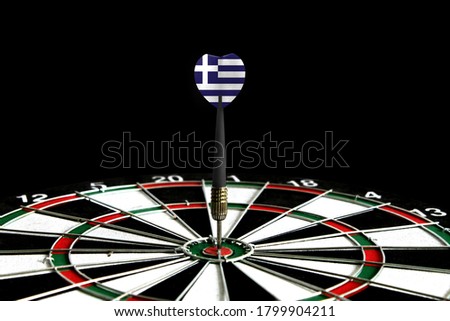 The flag of Greece is featured on the dart board game, the concept of achieving goals.