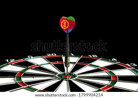 The flag of Eritrea is featured on the dart board game, the concept of achieving goals.
