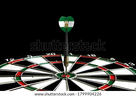 The flag of Andalusia is featured on the dart board game, the concept of achieving goals.