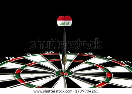 The flag of Iraq is featured on the dart board game, the concept of achieving goals.