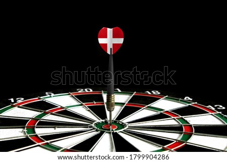 The flag of Denmark is featured on the dart board game, the concept of achieving goals.