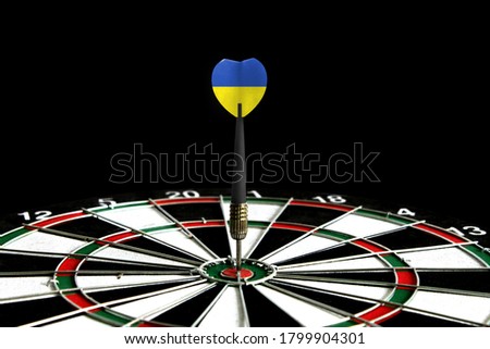 The flag of Ukraine is featured on the dart board game, the concept of achieving goals.