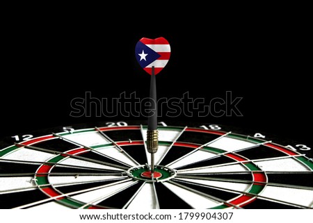 The flag of Puerto Rico is featured on the dart board game, the concept of achieving goals.