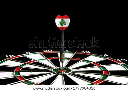 The flag of Lebanon is featured on the dart board game, the concept of achieving goals.