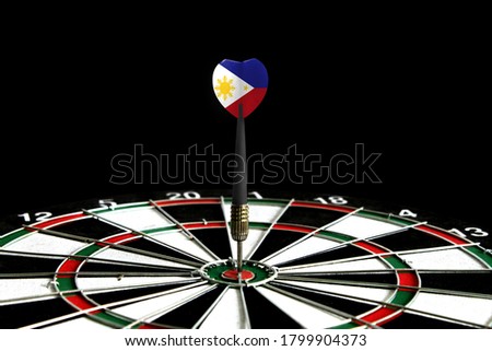 The flag of Philippines is featured on the dart board game, the concept of achieving goals.