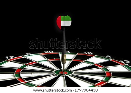 The flag of United Arab Emirates is featured on the dart board game, the concept of achieving goals.