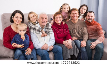 Family members making family photo during reunion party on sofa 