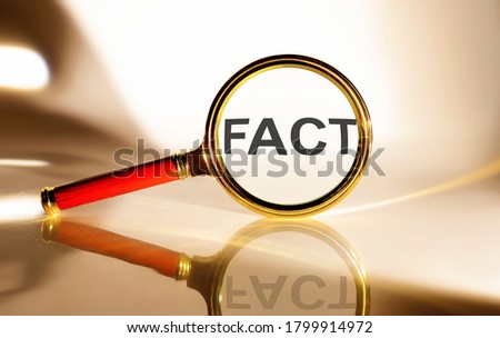 FACT concept. Magnifier glass with text on the white background in sunlight.