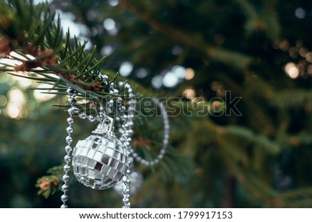 White glass christmas decoration on christmas tree. Festive background. New year greeting card. Banner with retro decor.