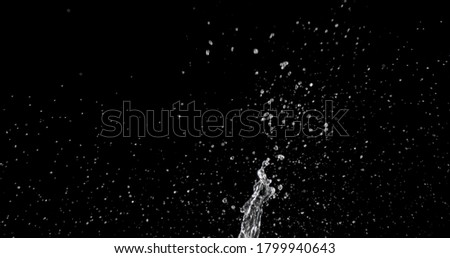 water being thrown against a black background.