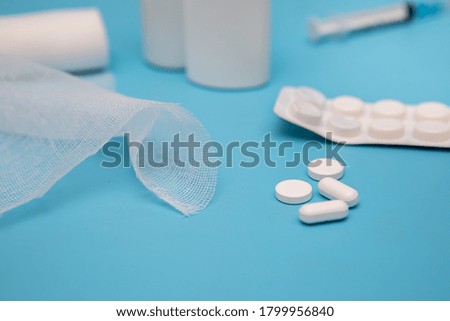 Nasal spray, pills, syringe, bandage injection on a blue background. Medicine concept. Mockup.