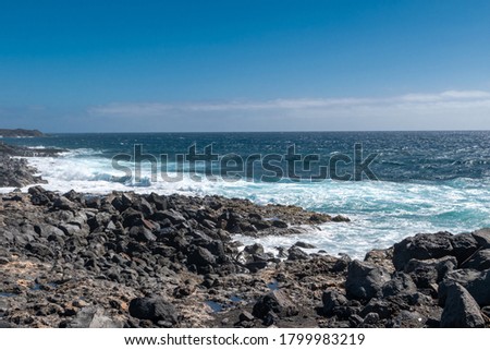 Sea and waves on the rocky shores of the volcanic island of Lanzarote, Canary Islands, Spain