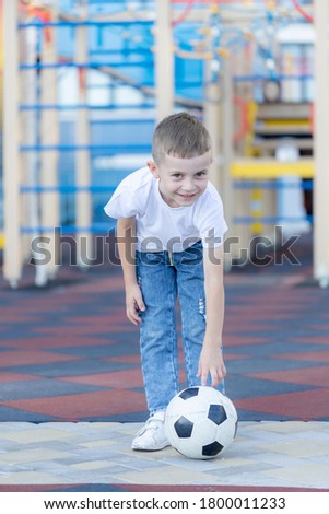 little boy with a soccer ball on the Playground