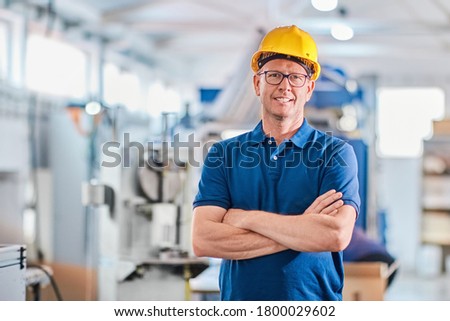 Successful foreman manager working with data and controlling work of industrial machine Royalty-Free Stock Photo #1800029602