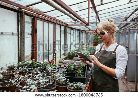 woman gardener working in greenhouse