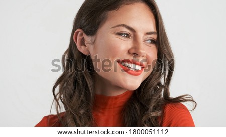 Portrait of beautiful smiling brunette girl happily posing on camera isolated