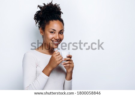 Portrait of happy woman thinking and looking into camera on white background