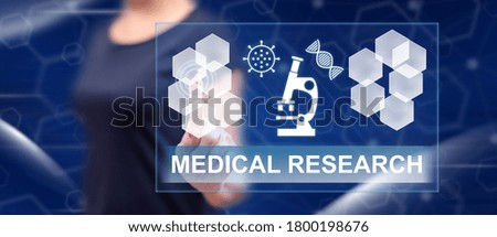 Woman touching a medical research concept on a touch screen with her finger